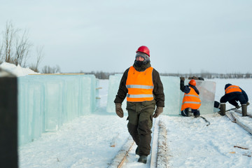 Slinger in an orange helmet walks down the assembly site