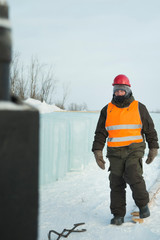 Slinger in an orange helmet walks down the assembly site