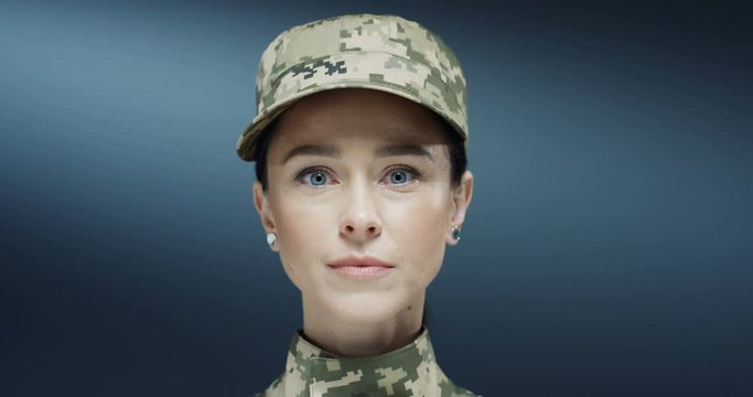 Portrait shot of the Caucasian young attractive brunette woman from US army looking straight to the camera. Close up.