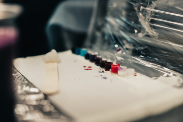 set of paints on table near the master’s tattoo