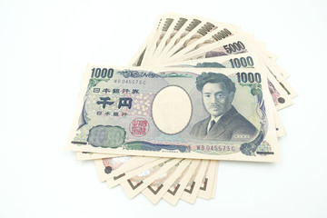 Close up of variety of Japanese yen currency banknotes lay flat and isolate on white background...