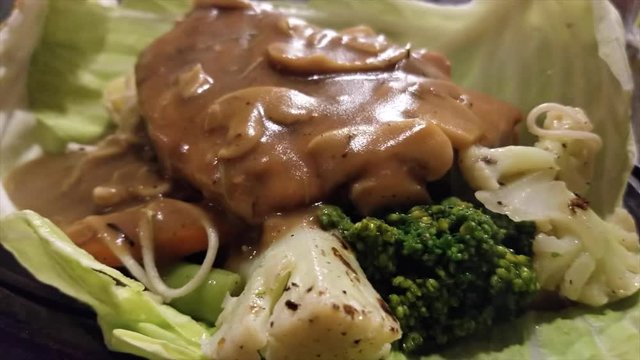 A Chicken And Yak Steak Sizzler On A Steaming Hot Plate.