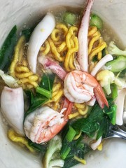 Thai noodles topped with seafood in gravy
