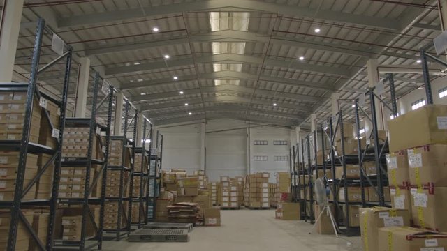Wide Shot Of Boxes In A Big Warehouse Facility