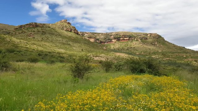 Stunning time lapse with shadows moving across landscape and mountains with interesting cloud formations and flower movements, Camelroc Moluti Mountains near Lesotho