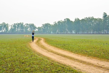 Thai girl walking in a wide field