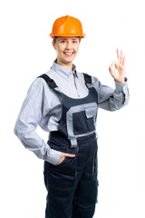 Successful young female engineer doing ok hand sign looking excited. Isolated