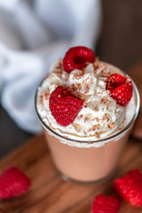 Homemade chocolate mousse with whipped cream, raspberries and chocolate shavings on top