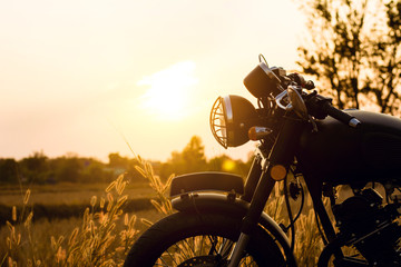 Fototapeta na wymiar Cose-up silhouette of motorbike on sunset background,Enjoying freedom and active lifestyle.