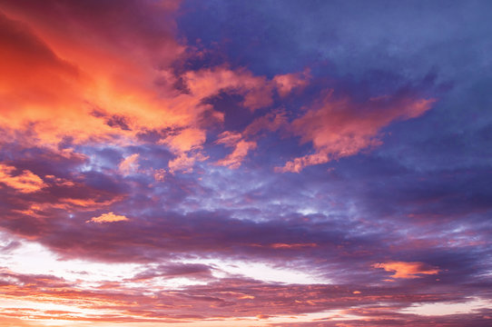 Beautiful red vibrant burning sunset sky with clouds