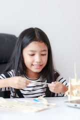 Asian little girl crafting wooden model select focus shallow depth of field