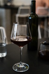 Glass of red wine on table