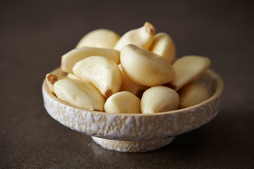 Peeled garlic background, studio shot 