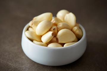 Peeled garlic background, studio shot 