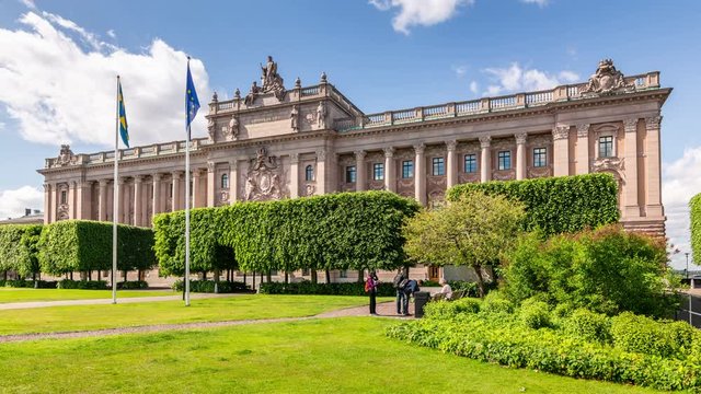 Parliament House of Sweden, located on Helgeandsholmen island in Gamla Stan the old town of Stockholm. Clouds move fast across the blue sky. Time lapse video. 