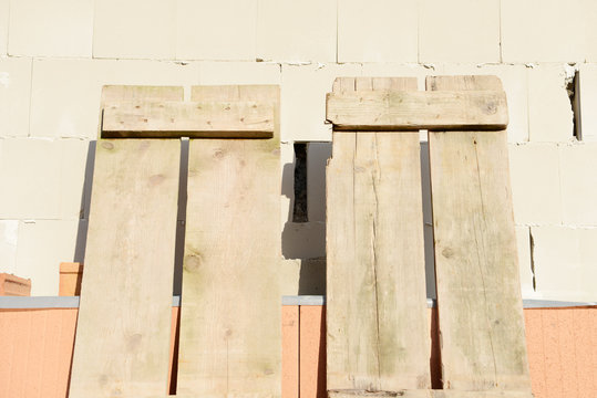wooden scaffold boards at house wall on the construction site