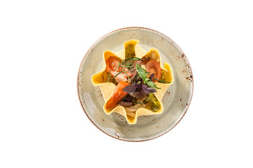 Beef salad with mixed vegetables served in tortilla bowl isolated on white background
