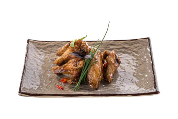 Fried Chicken Wings with green onion on grey plate isolated on white background