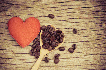 coffee beans on wooden spoon and red heart romantic love valentines day on rustic wood background / love coffee concept
