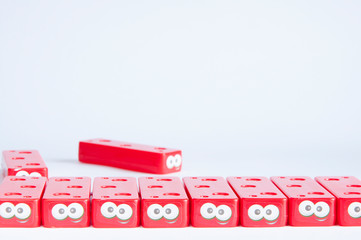 The children's plastic designer of red color folded in a row. Artificial eyes. On white background