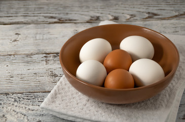 eggs in a ceramic bowl on wooden table