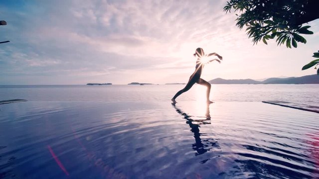 Slim woman doing chinese Tai Chi on beach