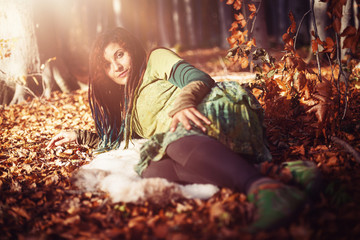 Beautiful woman with long dreadlocks in nature.