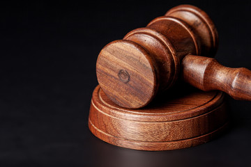 Wooden judges gavel on table close up