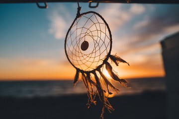 Dreamcatcher hanging on the beach with the beautiful view of sunset in the background