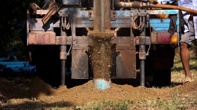 slow-motion of ground drilling water machine on the old truck drilling in the ground for water