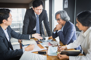 Discussing plan and idea to improvement strategy, businessmen brainstorming for strategy of business investment,businessmen review chart and document of investment information