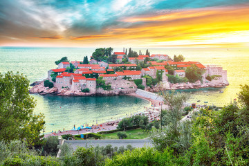 Aerial sunset view of the islet Sveti Stefan from church st. Sava viewpoint - obrazy, fototapety, plakaty