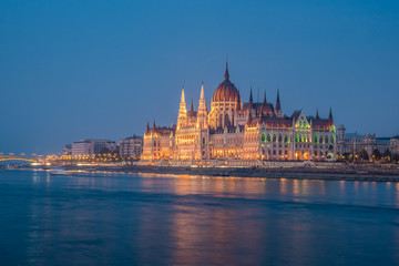 Fototapeta na wymiar Hungarian Parliament building and Danube River in the Budapest city in the evening. A sample of neo-gothic architecture.