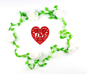 red heart shape which engrave into letter love in white rose vine frame on white background, image for valentine and wedding concept
