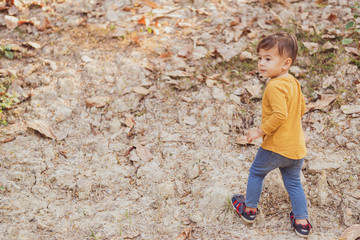 happy young boy playing outdoors in the park