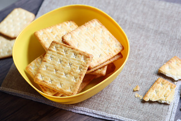 delicious wafer cracker with sugar biscuit crackers in yellow bowl on sack