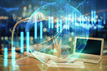 Double exposure of chart and financial info and work space with computer background. Concept of international online trading.