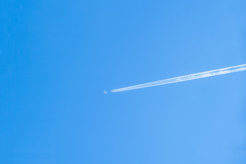 jet airplane with trail of fuel on blue sky, A long trail of jet plane on blue sky