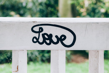 Love lettering on a white wooden bench