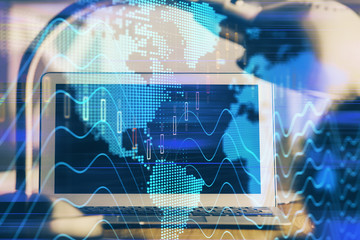Forex market graph hologram and personal computer on background. Double exposure. Concept of investment.