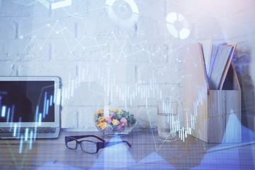 Forex market graph hologram and personal computer on background. Double exposure. Concept of investment.