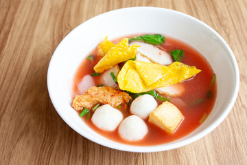 Asian noodle call Yentafo noodle with meat ball tofu and pork  with red soup 