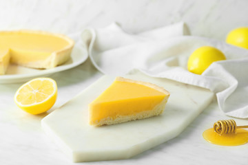 Slice of tasty homemade lemon pie on table