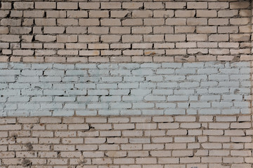 texutre of a brick wall with a white painted band