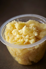 Crushed garlic in plastic bowl 