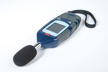 Sound level meter off. Sound level meter lies on a white background. Apparatus for measuring noise at a construction site. A device for measuring sound. Objective instrument noise level meter