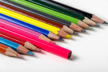 close up macro shot of colorful pencils on white background