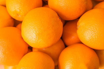 Many tasty oranges as background