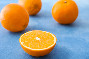Sweet tasty oranges on color background