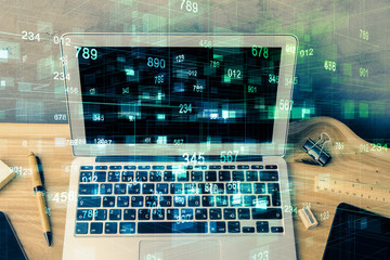 Double exposure of desktop computer and technology theme hologram. Concept of software development.